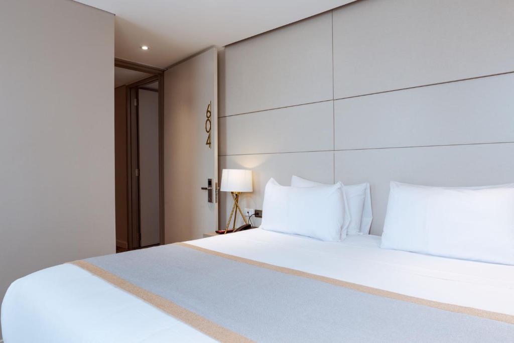 Postel nebo postele na pokoji v ubytování Hotel City Bog Corferias