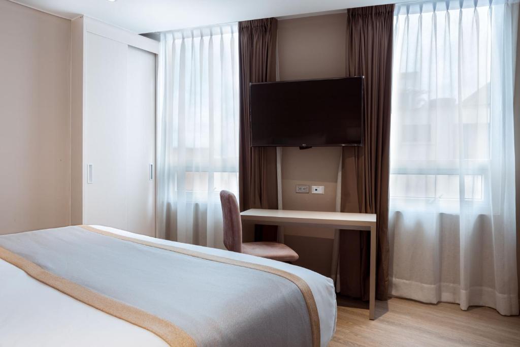 Postel nebo postele na pokoji v ubytování Hotel City Bog Corferias