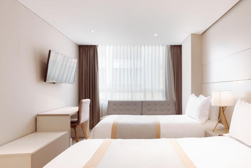 Postel nebo postele na pokoji v ubytování Hotel City Bog Corferias