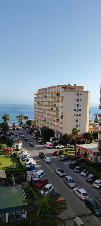 a parking lot with cars parked in front of a building at Estudio TORROX PLAYA- vistas al mar y piscina in Torrox Costa