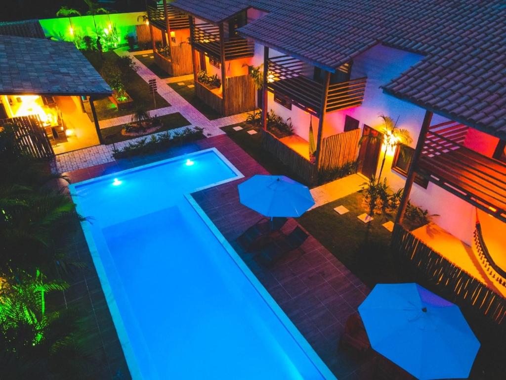 an overhead view of a house with a swimming pool at night at Pousada Vila Mangaba in Arraial d'Ajuda