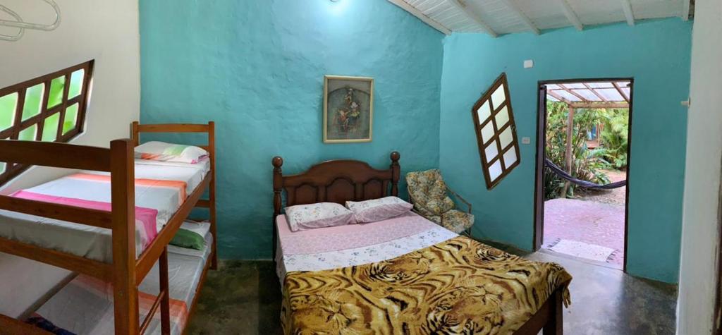 A bed or beds in a room at Recanto das Margaridas
