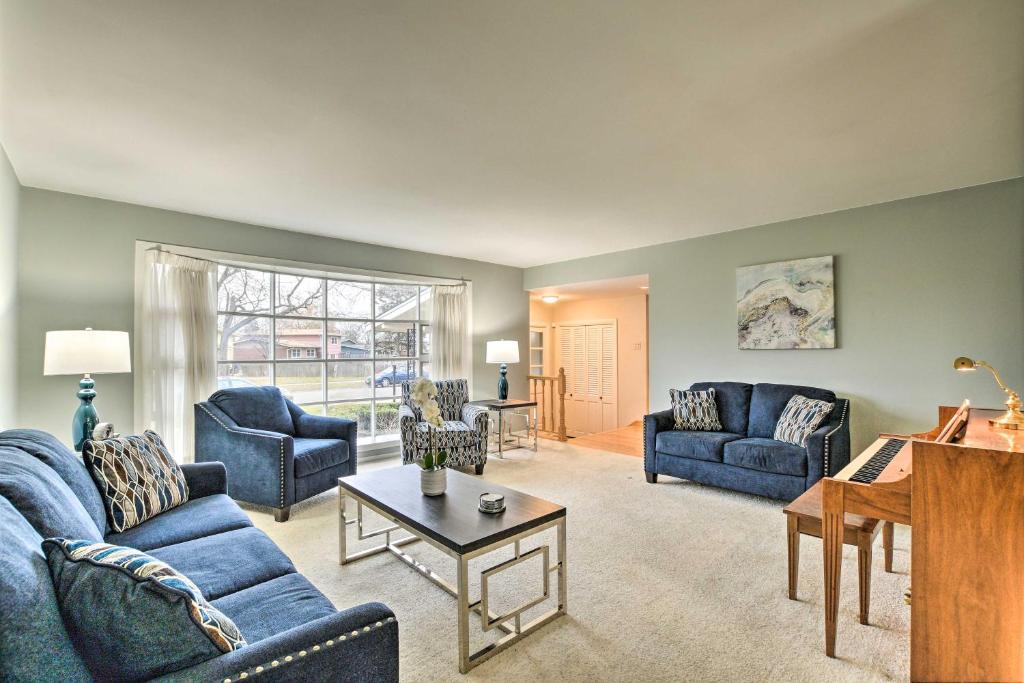 a living room with blue couches and a piano at Spacious Family Glenwood Estates Home with Hot Tub! in Glenwood