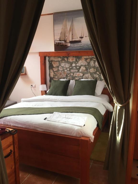 a bedroom with a large bed with a curtain at 4REST VILA in Pag
