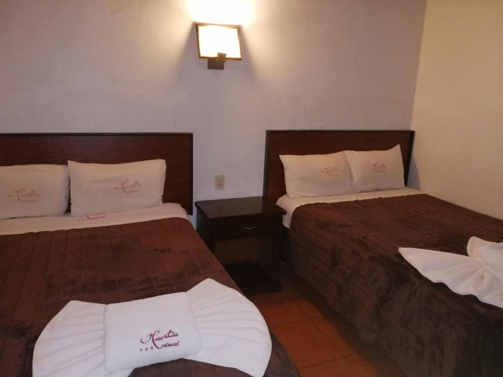 Postel nebo postele na pokoji v ubytování Hotel Colonial