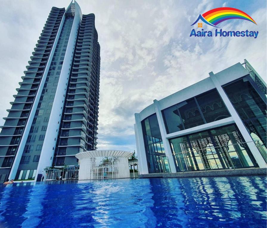um par de edifícios com uma piscina à frente deles em AAIRA Troika Residence,Kota Bharu em Kota Bharu