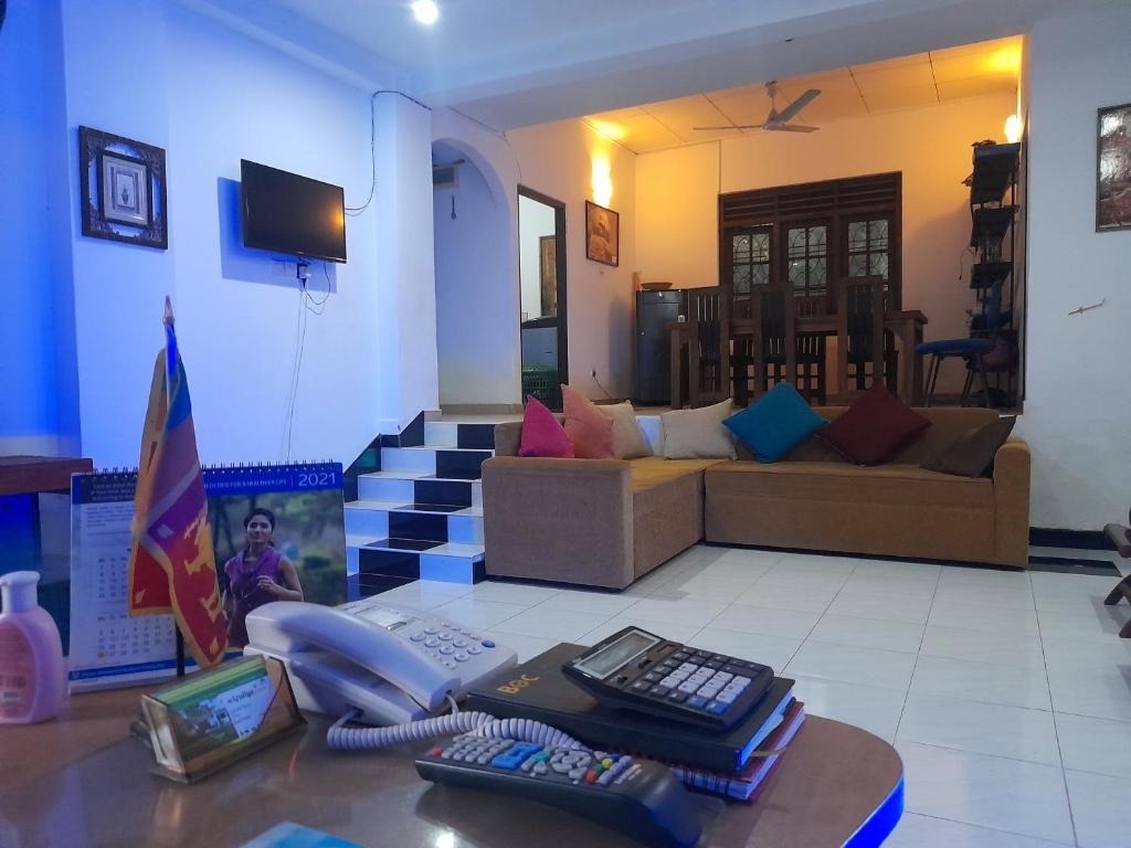 a living room with a couch and a telephone at Smart Holiday Inn in Galle