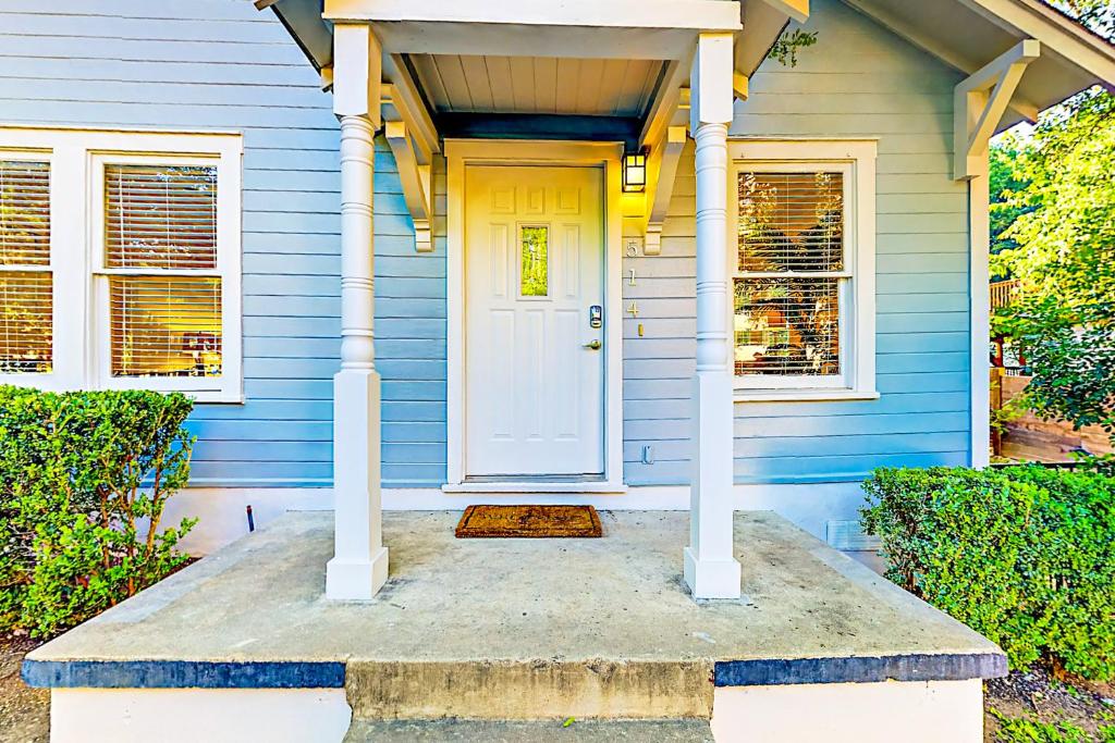 a blue house with a white door at Beautiful South in Austin