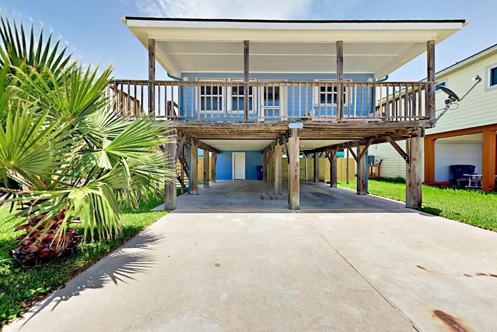 a house with a large deck on a sidewalk at Sunflower Hello in Port Aransas