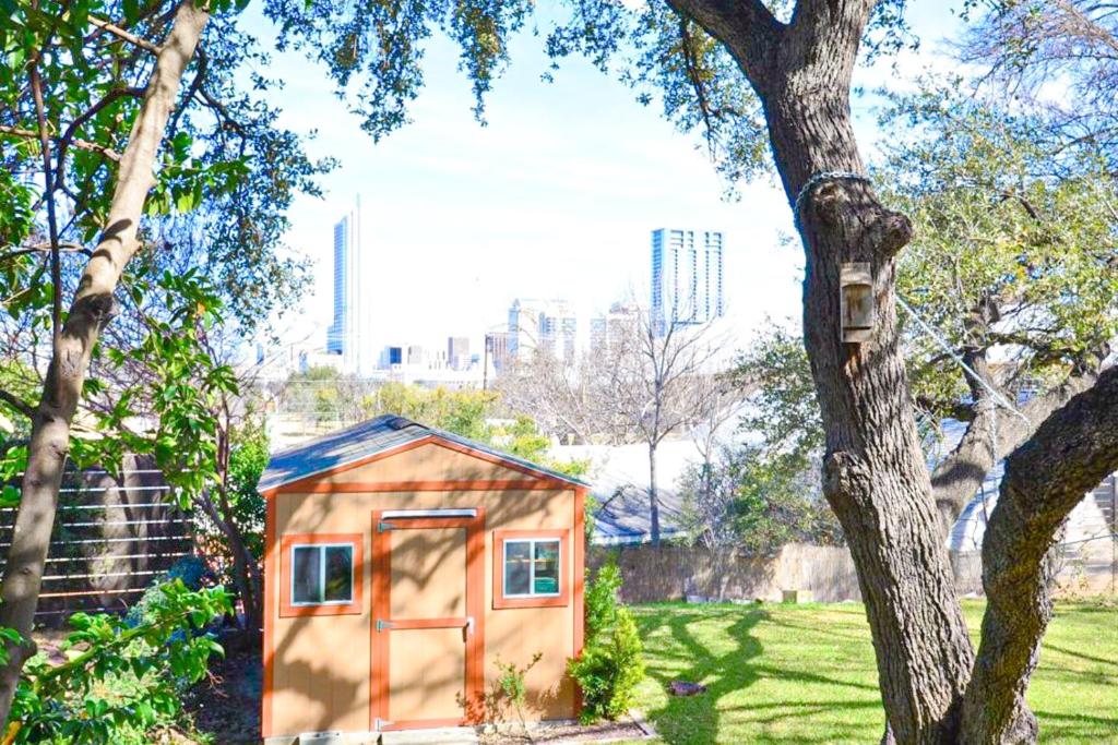 a tiny house in a park with a tree at Chill-Ville in Austin