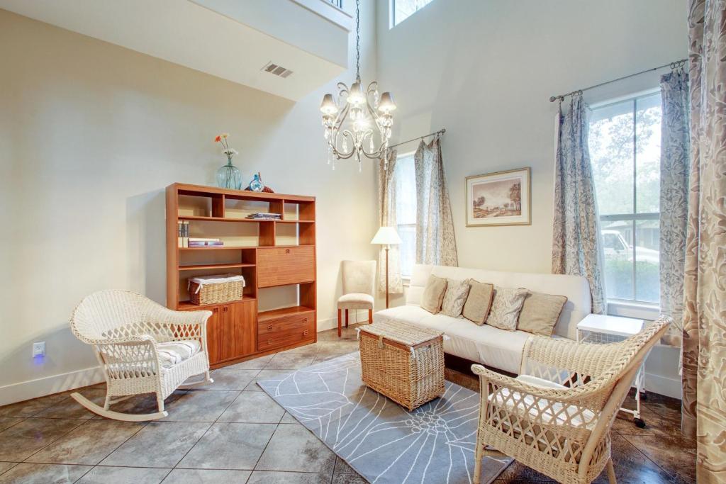 a living room with a couch and chairs and a chandelier at Rosedale Hideaway in Austin