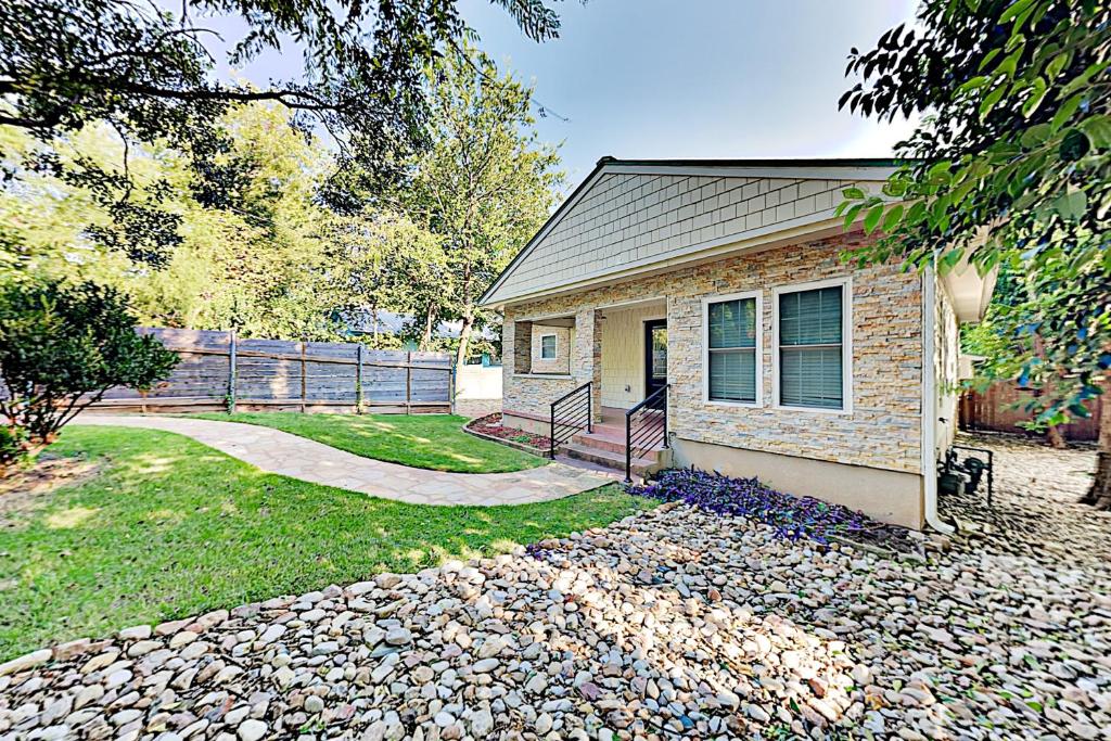 a small house with a stone walkway leading to it at Charming Delight in Austin