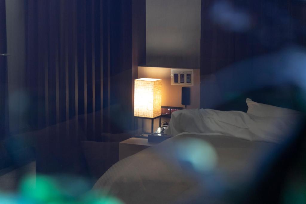 Postel nebo postele na pokoji v ubytování Hotel Gendairakuen Isehara