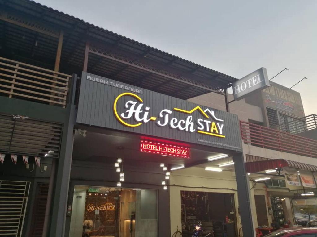 a store front with a sign for a tech shop at Hi TechSTAY in Lunas
