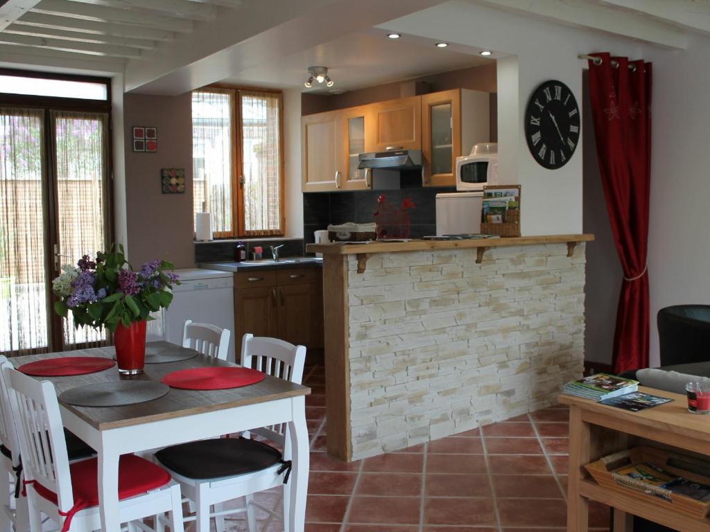 a kitchen and living room with a table and chairs at Gîte Senonches, 3 pièces, 4 personnes - FR-1-581-74 in Senonches
