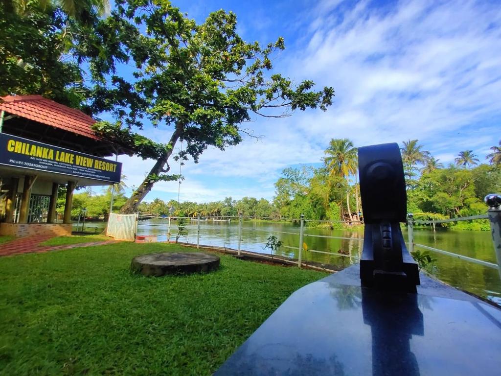 a car parked next to a body of water at Chilanka Lake view Resort in Alleppey