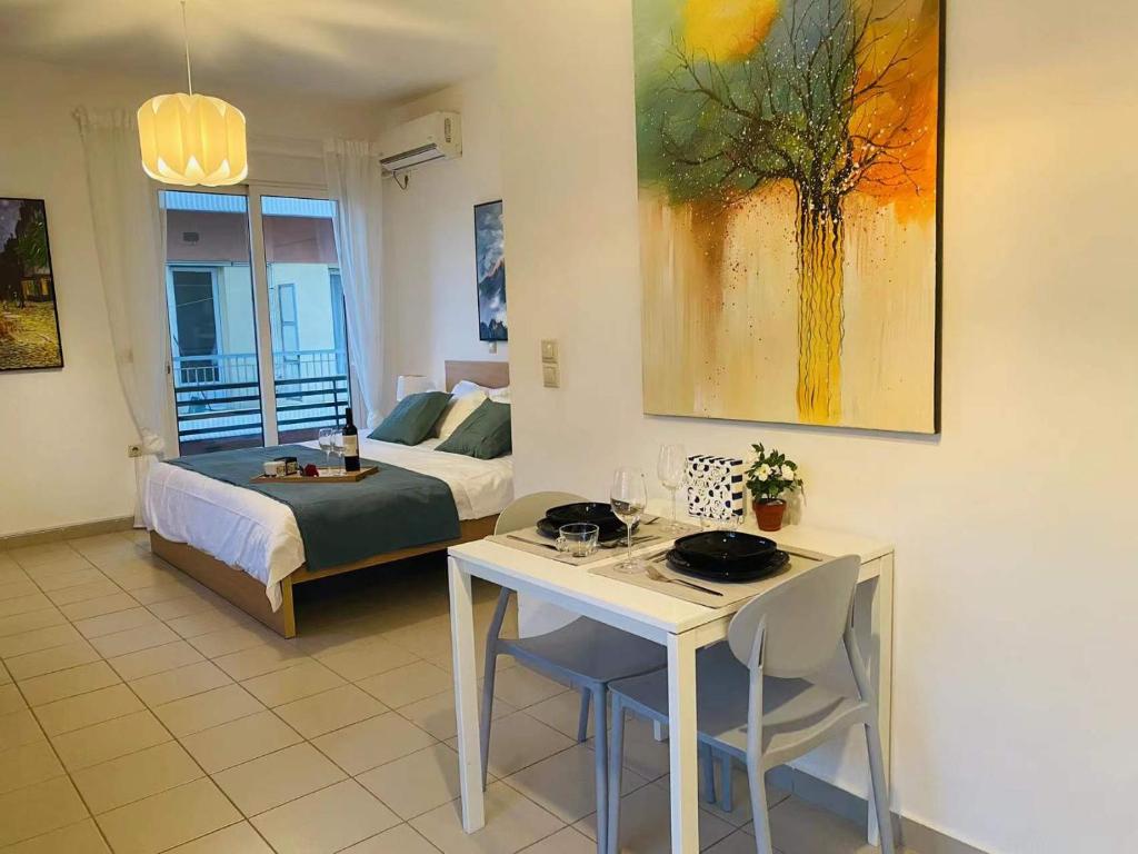 a living room with a bed and a table with chairs at New Times Home&Suites in Athens