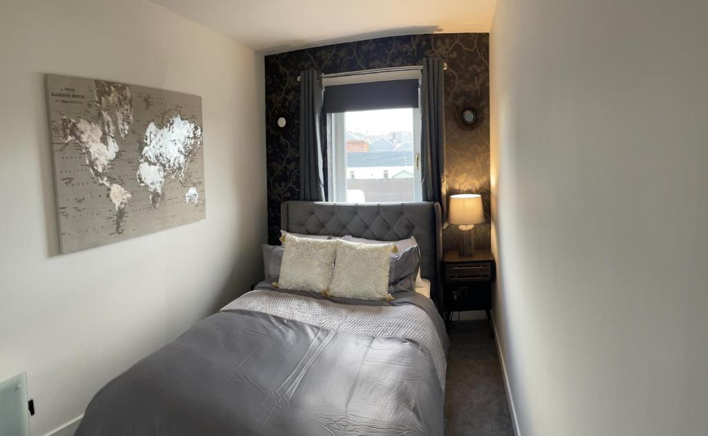 1 dormitorio con 1 cama y un mapa en la pared en holiday apartment en Ardrossan