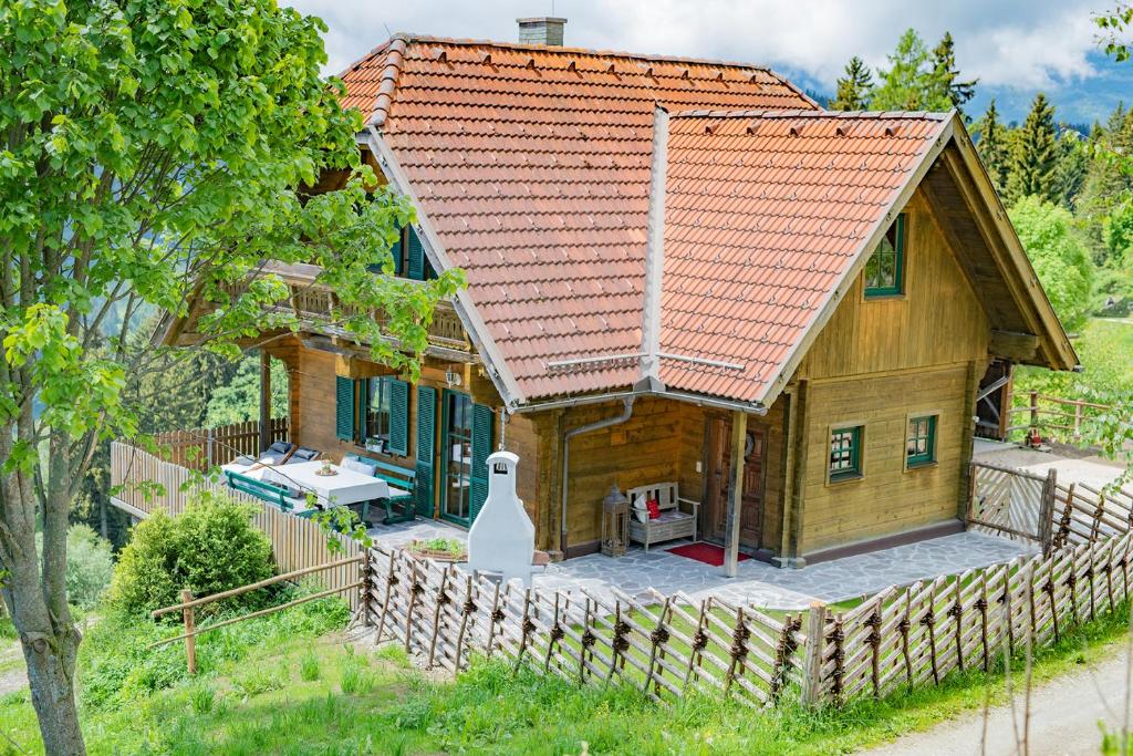 a wooden house with an orange roof at Kogljahrerhütte in Wolfsberg