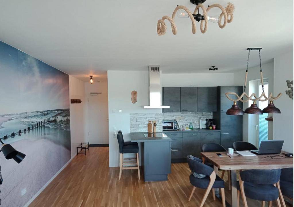 a kitchen and dining room with a table and chairs at Ferienwohnung Riverfront in Kappeln