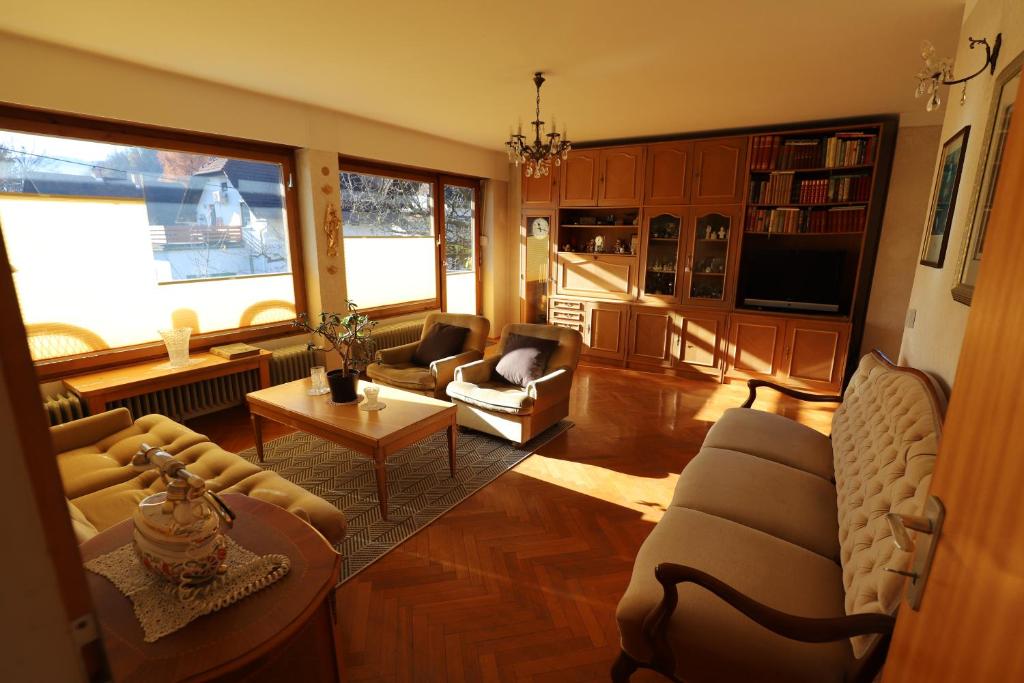 ein Wohnzimmer mit Sofa, Stühlen und einem Tisch in der Unterkunft Vintage Apartment Bled in Bled
