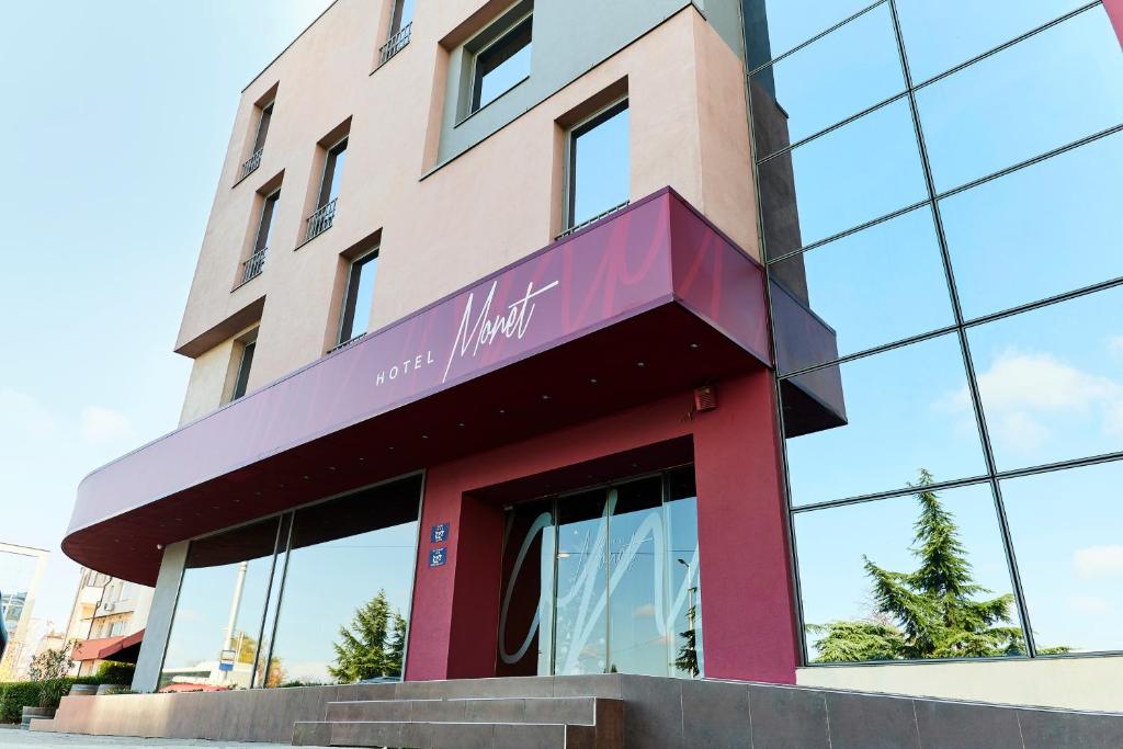 a building with a sign on the front of it at Monet Hotel in Plovdiv