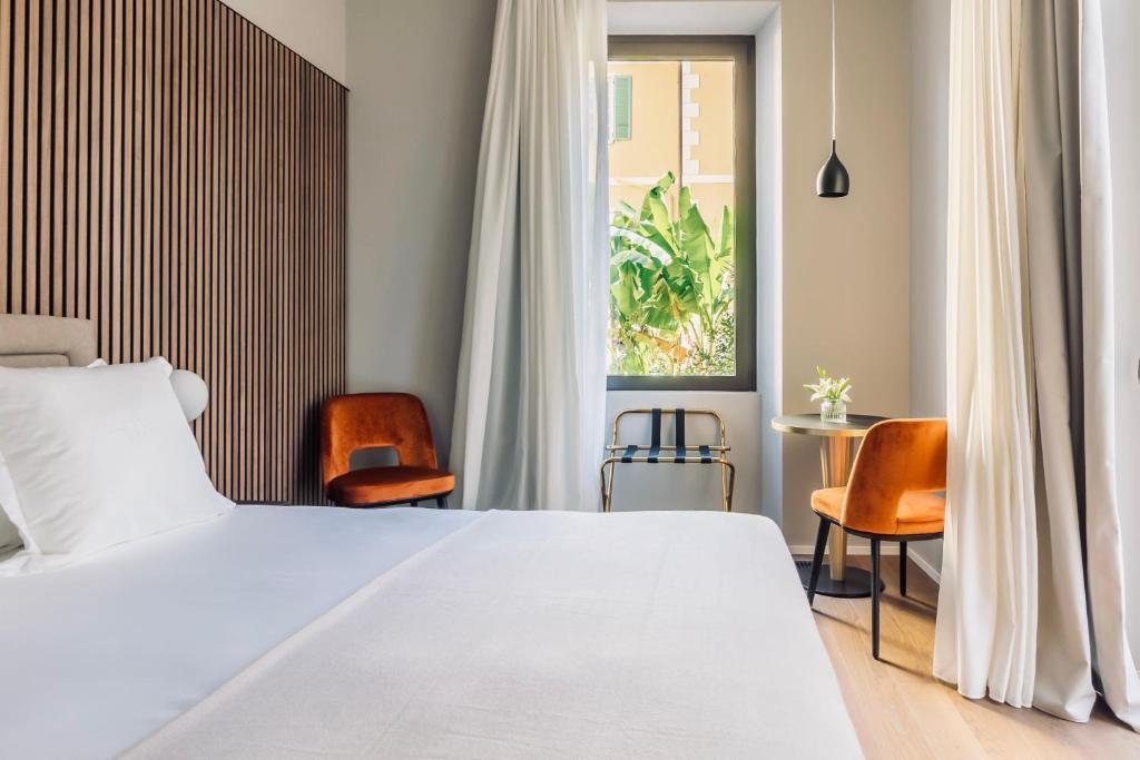 En eller flere senge i et værelse på Binario 934 Boutique Hotel