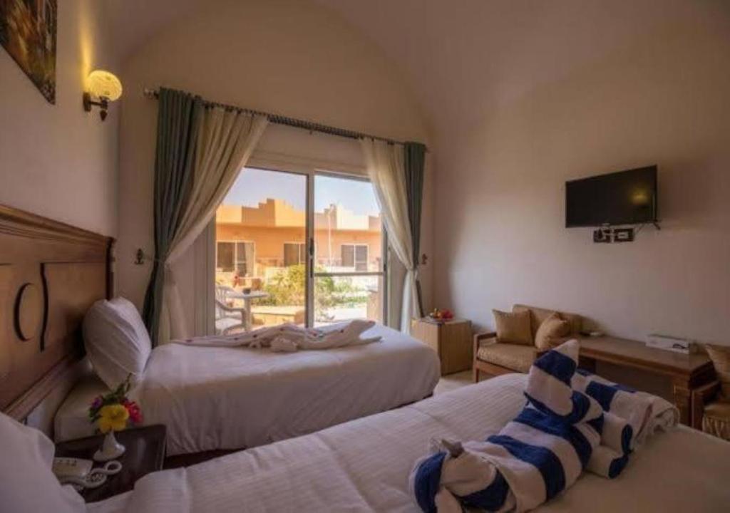 Postel nebo postele na pokoji v ubytování Silver Beach Boutique Hotel