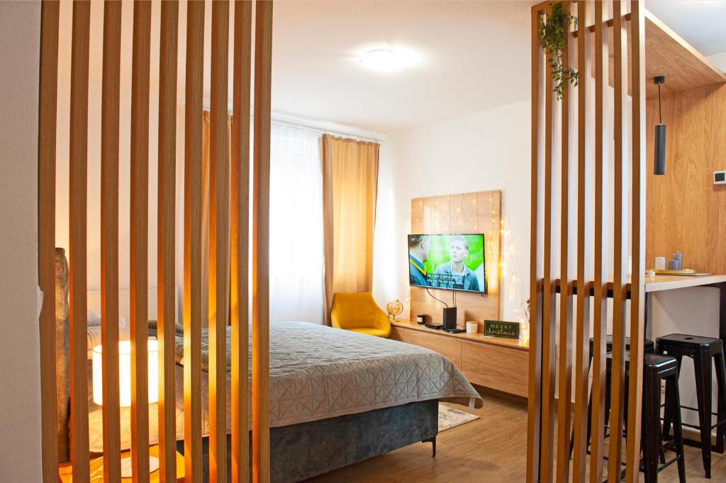 a bedroom with a bed and a yellow chair in it at TeonaLux Kraljevi Cardaci 5a/22 in Kopaonik