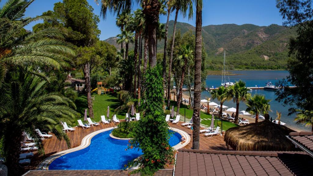 a view of a resort with a swimming pool and palm trees at Joya Del Mar Hotel in Marmaris