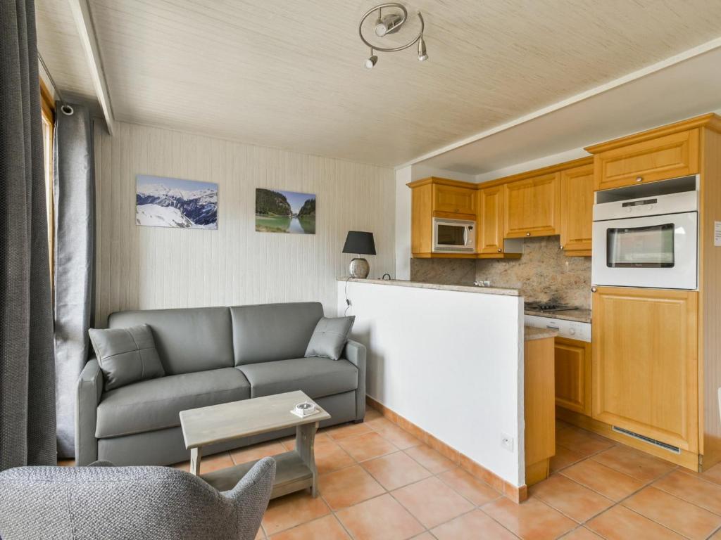 a living room with a couch and a kitchen at Appartement Courchevel 1650, 2 pièces, 5 personnes - FR-1-514-65 in Courchevel