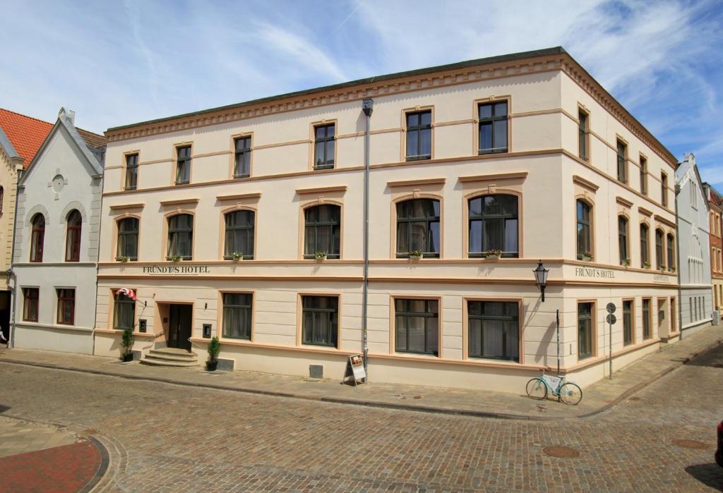 a building with a large window on the side of it at Fründts Hotel in Wismar