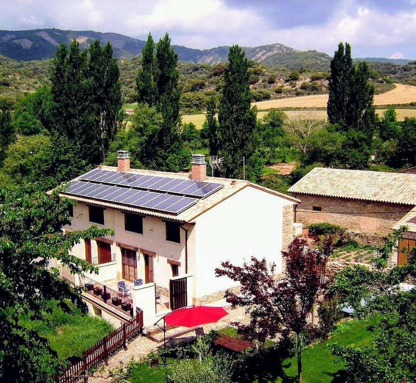 a house with solar panels on the side of it at Casa Rural Las Lezas in Biel