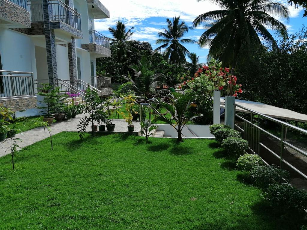 a garden in front of a house with plants at Marlene's Hilltop Villa in Cebu City