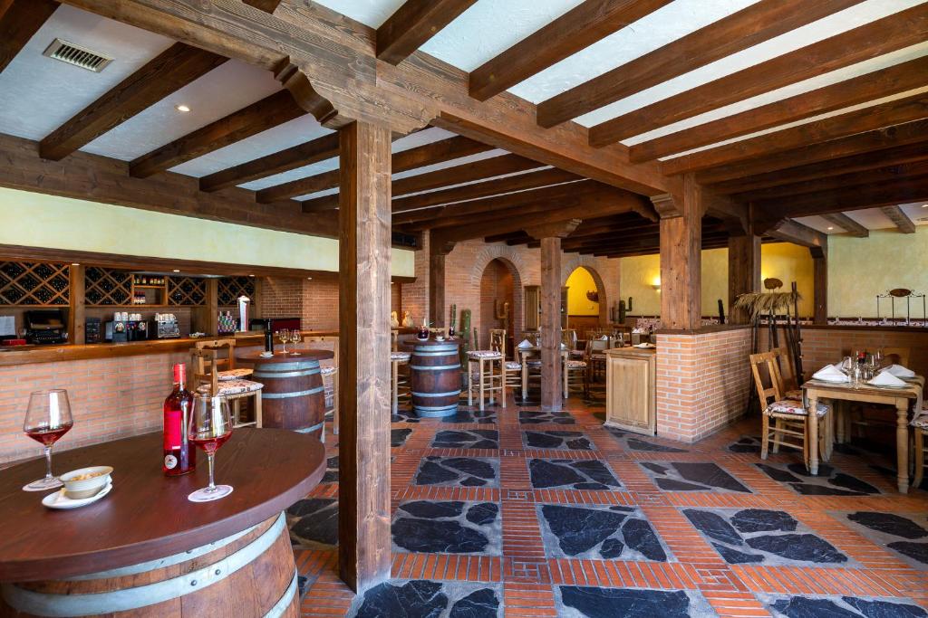 a tasting room with barrels and a bar with wine glasses at Hotel LIVVO Volcán Lanzarote in Playa Blanca
