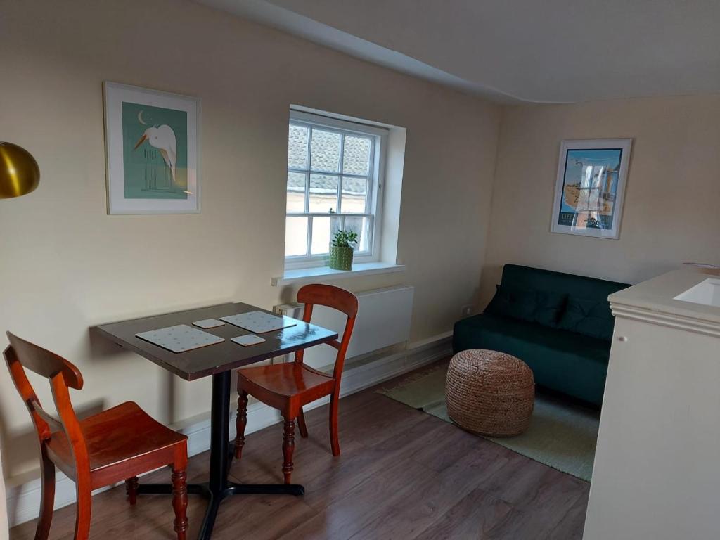 a living room with a table and chairs and a couch at Loft in Bungay in Bungay