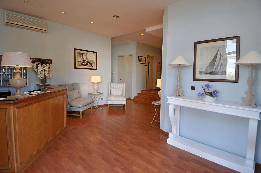 a large living room with a fireplace and a living room at Hotel Santa Maria in Saint-Florent
