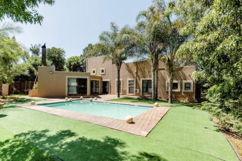 a house with a swimming pool in the yard at iShoba Retreat in Centurion