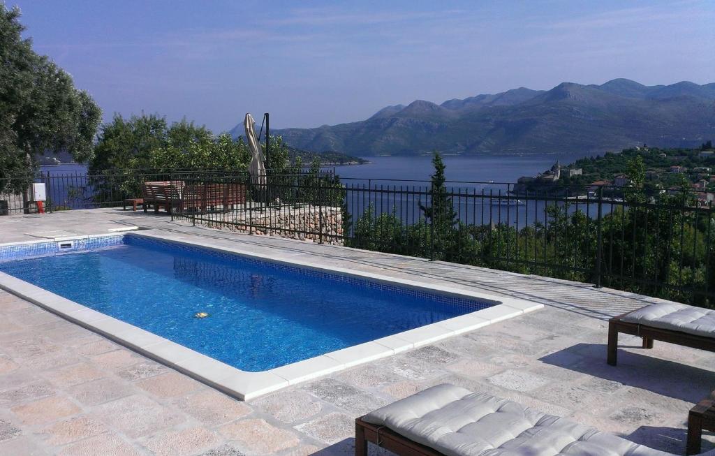 a swimming pool with a view of the water at Villa Lopud In Dubrovnik in Lopud Island