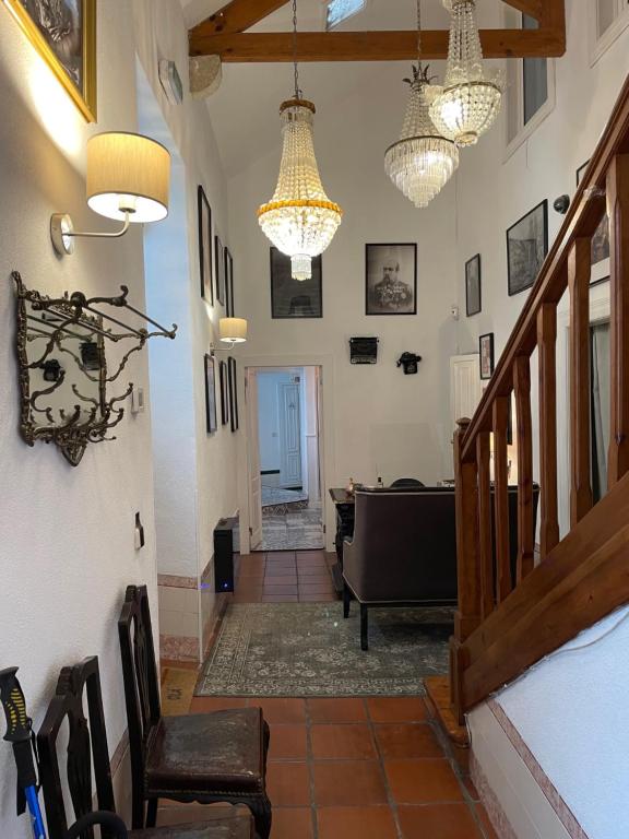 a hallway with chairs and chandeliers in a house at Sintra1012 Boutique Guesthouse in Sintra
