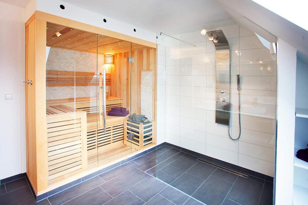 a large bathroom with a shower and a sink at Ferienhaus Dieboldsberg in Alpirsbach