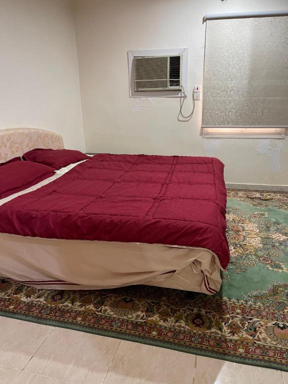 Madain Saleh的住宿－شاليه الفاخريه，卧室内的一张床位,配有紫色棉被