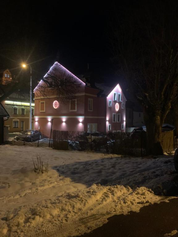 a house with lights on the side of it at night at Apartmány TIME in Jáchymov