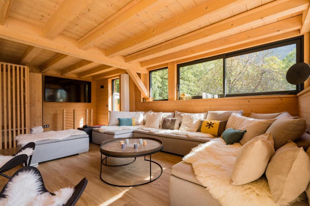 a living room with a couch and a table at Chalet nature et design in Servoz