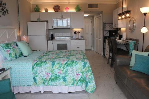 a bedroom with a bed and a kitchen and a living room at Just For You in Fort Walton Beach