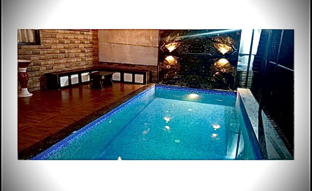 a swimming pool in the middle of a room at Mount bungalows-Mount cottage-wifi-pvt pool in Lonavala