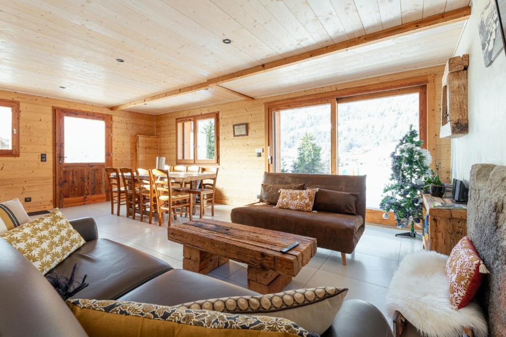 a living room with a couch and a table at Les Picaillons - Le Chalet in Les Villards-sur-Thônes