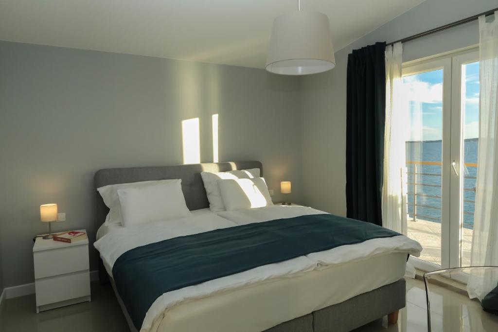 Postel nebo postele na pokoji v ubytování Sunset Apartment Padrele