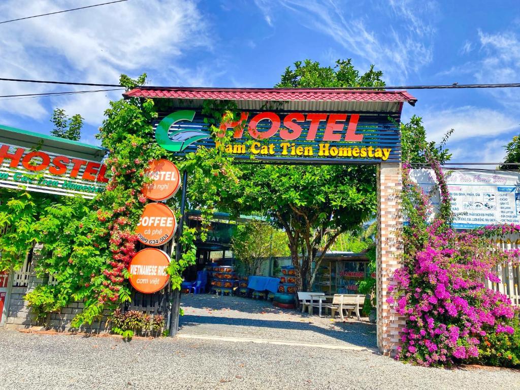 um sinal para um hostel que está coberto de flores em Nam Cat Tien Homestay em Cat Tien