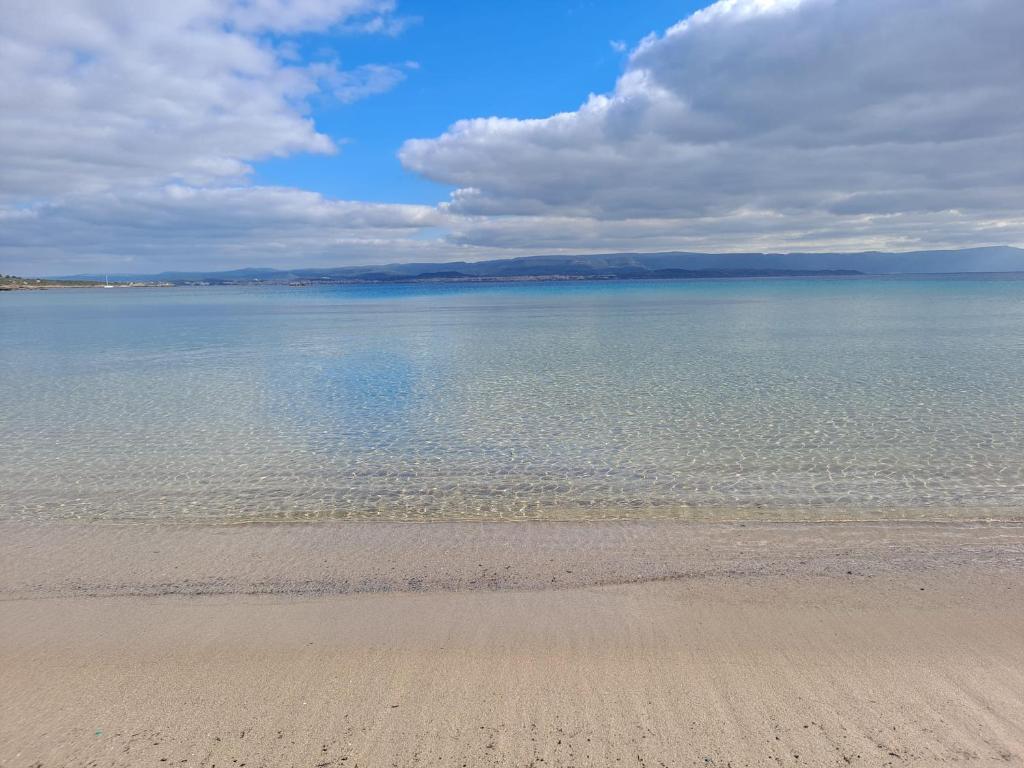 a view of the ocean from a sandy beach at Alghero Heart in Alghero